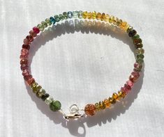 "Lovely multicolored tourmaline bead bracelet. Pinks greens yellows blues rainbow assortment of gemstones. Sterling silver clasp. About 7 1/2\" long." Bracelet Rainbow, Rainbow Gemstones, Tourmaline Bracelet, Cat Ring, Blue Rainbow, Tourmaline Beads, Silver Spoons, Jewelry Cleaner, Bead Bracelet