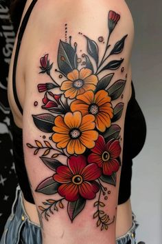 a woman's arm with flowers and leaves tattooed on the side of her body