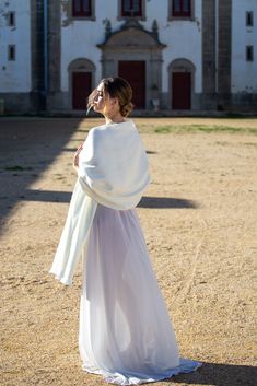 This ivory wedding shawl matches perfectly with off-white ivory dresses, but also brightens up darker or creamier wedding dress. It is a warm, off-white shade. Ivory and Pure White are both shades of white, but they differ in tone and warmth. Ivory has a subtle hint of warmth with a soft, creamy undertone. It tends to feel more organic and elegant. In contrast, Pure White is a clean, bright, and cool shade with no undertones of color, giving it a stark, crisp appearance. Pure White is often asso Cream Pashmina Shawl For Wedding, White Wedding Pashmina Shawl, Elegant Beige Wedding Wraps, White Shawl Wrap For Wedding, Wedding Cream Pashmina Shawl, Winter Beige Alpaca Shawl, Elegant Alpaca Shawl, Ivory Fur Shawl, White Bohemian One-size Shawl