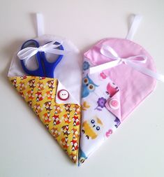 three baby bibs with different designs on them, one is pink and the other is yellow