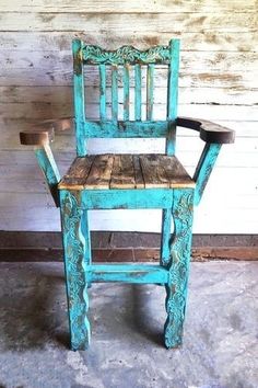 an old wooden chair sitting in front of a wall