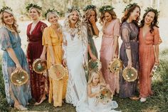 a group of women standing next to each other wearing dresses and wreaths on their heads