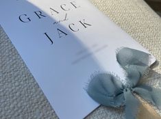 a close up of a piece of paper on top of a bed with the words grace and jack written on it