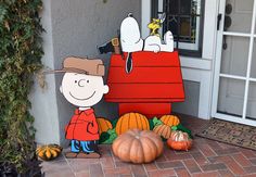 a charlie brown thanksgiving yard decoration with pumpkins