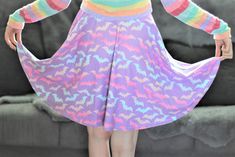 "A purple skirt featuring rainbow bats designed for so many spooky possibilities. The skater skirt, which has a slinky, slightly shiny knit feel, also has soft fabric and an elastic waistband. This piece will be a showstopper in your pastel goth wardrobe. Great for both dark and pastel COORDs. Apparel and bedding ship separate from handmade items. Delivered in 2-4 weeks. ✰ ★ ✰ ★ ✰ ★ ✖️ 82% polyester, 18% spandex (mid-weight jersey) ✖️ Machine-washable cold cycle. Tumble dry low, do not bleach ✖️ Purple Skirt For Halloween Costume Party, Cute Fitted Purple Skirt, Purple Pastel Goth, Skirt Kawaii, Goth Wardrobe, Kawaii Skirt, Goth Clothes, Purple Pastel, Purple Skirt