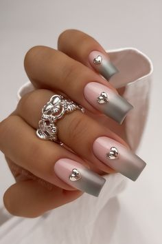 These square-shaped nails combine a subtle pink-to-grey ombre gradient with charming silver heart accents, creating a romantic and refined style. The glossy finish highlights the metallic details, making it perfect for Valentine’s Day or late February trends. This design can be achieved with SNS or gel short square techniques for durability and precision. Ombre Gradient, Grey Ombre, Classic Elegance, Silver Heart