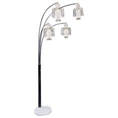 a black and white floor lamp with five crystal cubes on the top of it