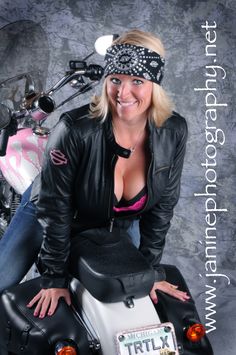 a woman sitting on top of a motorcycle