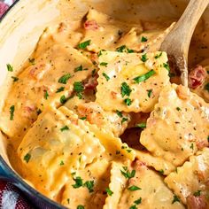 a pan filled with ravioli and cheese sauce