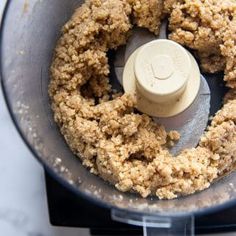 a food processor filled with crumbs sitting on top of a counter