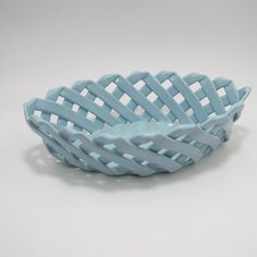 a blue bowl sitting on top of a white table