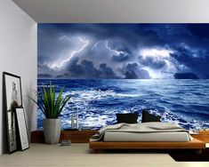 a bed room with a large wall mural and a big bed in the foreground