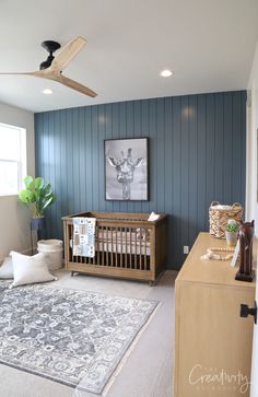 a baby's room with blue walls and white carpet