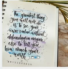 an open notebook with a quote on it