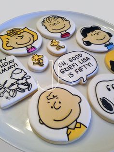 a white plate topped with cookies covered in cartoon characters