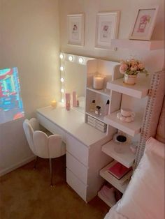 a white vanity with lights on it in a bedroom