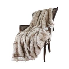 a chair with a blanket on top of it and a wooden frame in the back