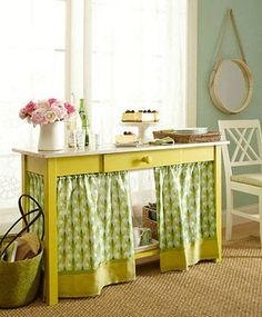 a yellow table with green and white curtains