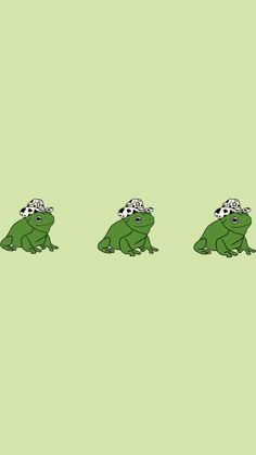 three green frogs with hats on their heads, one sitting down and the other standing up