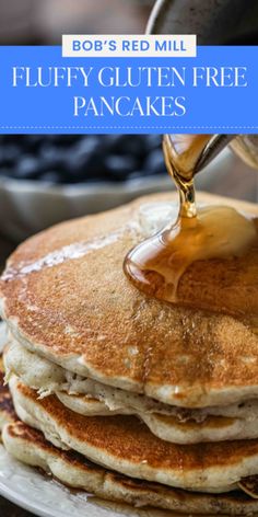 a stack of pancakes with syrup being poured onto them and the words bob's red mill fluffy gluten free pancakes