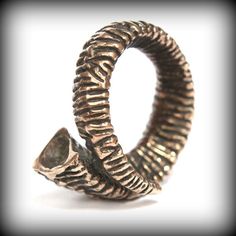 This 3D rams horn statement ring will turn heads no matter who is wearing it. The heavily textured ram horn will wrap your finger in style be you a guy or a gal. It is cast in solid jewelers grade bronze. The carving details are magnified by the alternating bright ridges and dark oxidized recesses. Ladies version is available herehttps://www.etsy.com/listing/242160380/ram-horn-ring-496?ref=shop_home_active_5&ga_search_query=ram%2Bhorn%2BringALTERNATIVE FINISH:https://www.etsy.com/listing/151 Rams Horn, Horn Ring, Button Studs, Ram Horns, Jewelry Care Instructions, Wrap Ring, Skull Ring, Wrap Rings, Nature Jewelry