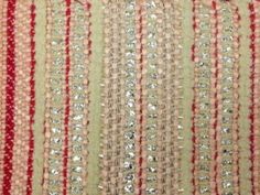 a red and white striped fabric with sequins