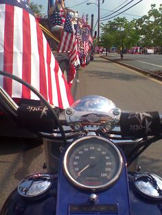 a motorcycle with an american flag on the back is parked in front of a row of other motorcycles