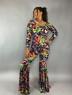 About this item Step into the comfort and glam with our stunning floral print Disco Jumpsuit!This Custom Bell Bottom Catsuit is the perfect choice for your next elegant party or festival outing. Each piece is meticulously crafted to measure, ensuring a flawless fit that's tailored just for you.Featuring luxurious crush velvet slightly see trough , this Glamorous Catsuit exudes royalty and sophistication.The bell bottom pants and long sleeves with a boat neck a captivating silhouette that's bound Spring Fitted Floor-length Jumpsuits And Rompers, Bohemian Jumpsuits And Rompers For Spring Party, Bohemian Maxi Length Jumpsuits And Rompers For Party, Bohemian Party Sets For Spring, Floral Print Pants For Party, Floral Print Long Sleeve Jumpsuits And Rompers For Party, Fitted Multicolor Tropical Print Bottoms, Floral Print Party Pants, Summer Floral Print Party Sets