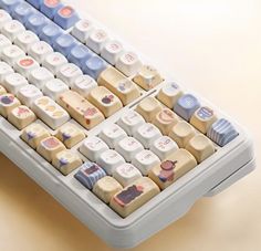 a close up of a keyboard with many different colors and designs on it's keys