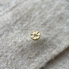 This beautiful 9ct gold flower stud is made up of a bright yellow natural diamond which is just 1mm across.  A perfect earring to sit in a curated ear look. Bringing some warm yellow gold to any look.   The earring itself is made out of solid 9ct yellow gold and is attached from behind the lobe with a screw ball back.  The gap between the front and the screw ball back is 5mm.  One single earring.   This ear stud was hand made by myself in my workshop in Surrey, England.  If you require more of t Gold Flower Charm Earrings In 14k Gold, 14k Gold Round Flower Earrings, Gold Flower Earrings With Flower Charm, Gold Round Flower Earrings In 14k Gold, Gold Flower Earrings In 14k Round Shape, 14k Gold Flower Charm Earrings, 14k Yellow Gold Round Flower Earrings, Yellow Gold 14k Round Flower Earrings, Yellow Gold Flower Earrings