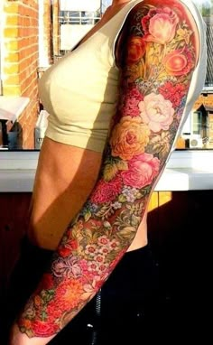 a woman's arm with flowers on it and an instagramr to the side