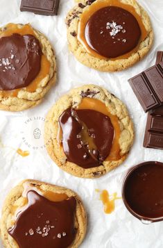 chocolate covered cookies with peanut butter and sea salt on top, next to some candy bars