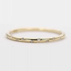 Aurora Designer - Diamond "Sprinkle" 14K Gold Wedding Band Stacking Ring Flush Set 10 Diamonds AD1147
♥  Solid 14K gold ring flush set with 10 diamonds, sprinkled evenly across the center of the ring  ♥  This is a simplistic design with half round band.  ♥  US Size 3-9  ♥  Band width: 1.3-1.5mm  ♥  Gemstone weight: 10 Minimalist Eternity Band With Single Cut Diamonds, Minimalist Yellow Gold Eternity Band With Diamond Accents, Minimalist Half Eternity Round Band, Minimalist Half Eternity Band, 14k Gold Wedding Band, Simplistic Design, 14k Gold Ring, Gold Wedding Band, Stacking Ring