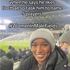 a woman wearing a beanie at a soccer game with the caption, when he says he likes football so i ask him to name 5 players