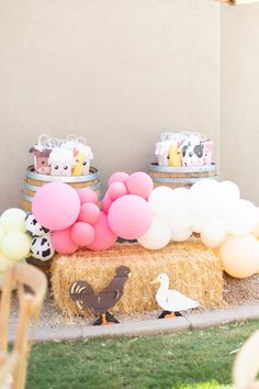 an outdoor party with balloons and farm animals