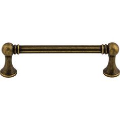 an antique brass pull handle on a white background