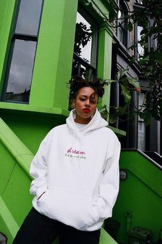 a woman standing in front of a green building 90s Letter Print Hoodie For Streetwear, 90s Style Letter Print Hoodie For Streetwear, 90s Style Hoodie Sweatshirt With Graphic Print, 90s Hooded Sweatshirt With Graphic Print, 90s Style Graphic Print Hoodie Sweatshirt, Sporty Streetwear Hoodie With Screen Print, Sporty Hoodie With Screen Print For Streetwear, 90s Hooded Graphic Print Sweatshirt, Streetwear Hoodie With Text Print