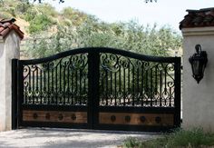 an iron gate is open to the driveway