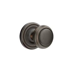 an antique style door knob with a dark bronze finish and two round knobs on each side