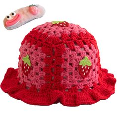 a crocheted strawberry hat with a strawberries design on it