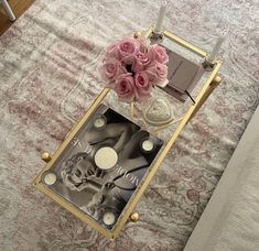 a glass table with pink roses on it and a mirror in the middle that says love