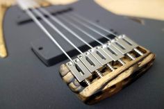 a close up of an electric guitar with strings