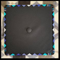 a black square with a button on it