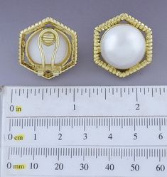 Presented is a lovely pair of 18 karat gold and pearl earrings. These are relatively modern earrings, likely made in Italy or elsewhere in Europe. The earrings are done in a hexagonal style, each set with a beautiful mabe pearl of about 18.5 millimeters in diameter. The gold settings are heavy and high quality, done in a ribbed design. The earrings have omega style clipbacks for wear with unpierced or pierced ears, but a jeweler could easily add posts so the earrings could be worn specifically f Elegant Octagon Earrings For Formal Occasions, Elegant Octagon Wedding Earrings, Elegant Gold Hexagon Earrings, Elegant White Gold Octagon Earrings, Elegant Hexagon-shaped Yellow Gold Jewelry, Luxury Gold Octagon Earrings, Elegant Hexagon Earrings For Gift, Elegant Gold Hexagon Jewelry, Elegant White Octagon Earrings