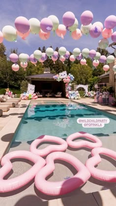 an inflatable pool is decorated with balloons and streamers to welcome the guests