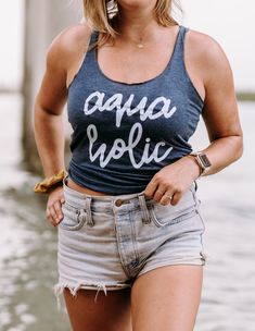 Aquaholic Ladies Racerback Tank: Dive into Summer Style! Make a splash this summer with our Aquaholic Ladies Racerback Tank! 🌊 Whether you're lounging by the pool, hitting the beach, or just dreaming of the ocean, this tank is perfect for all you water lovers out there. Crafted with soft, lightweight fabric, this tank is comfortable and breathable, perfect for those hot summer days. The racerback design adds a sporty touch, while the bold "Aquaholic" graphic lets everyone know where your heart Beach Season Tank Top With Letter Print, Summer Racerback Tank Top With Letter Print, Letter Print Tank Top For Beach Season, Casual Racerback Swimwear For Vacation, Casual Racerback Swimwear For Spring, Casual Racerback Swimwear For Summer, Casual Vacation Tank Top For Poolside, Casual Tank Swimwear For Summer, Casual Tank Top For Poolside Vacation