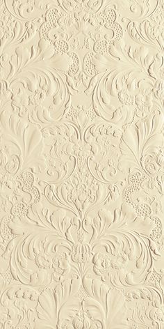 an ornate wallpaper pattern with white paint