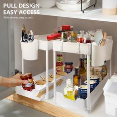 the pull design easy access shelf drawer is open and has food items on it, along with utensils