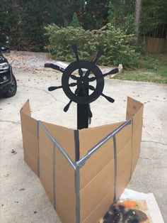 a boat made out of cardboard with a steering wheel