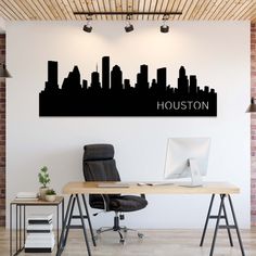 a desk with a computer on it in front of a city skyline wall decal